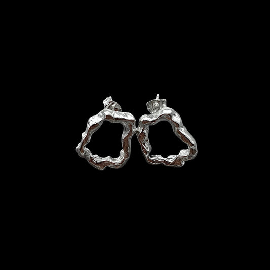 Silver hoop earrings on a black background